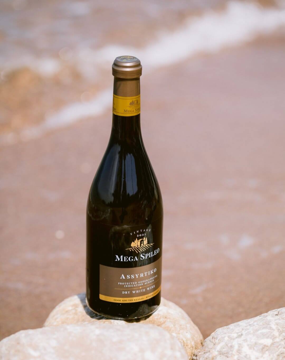 Mega Spileo "Assyrtiko" white wine bottle on rocky surface